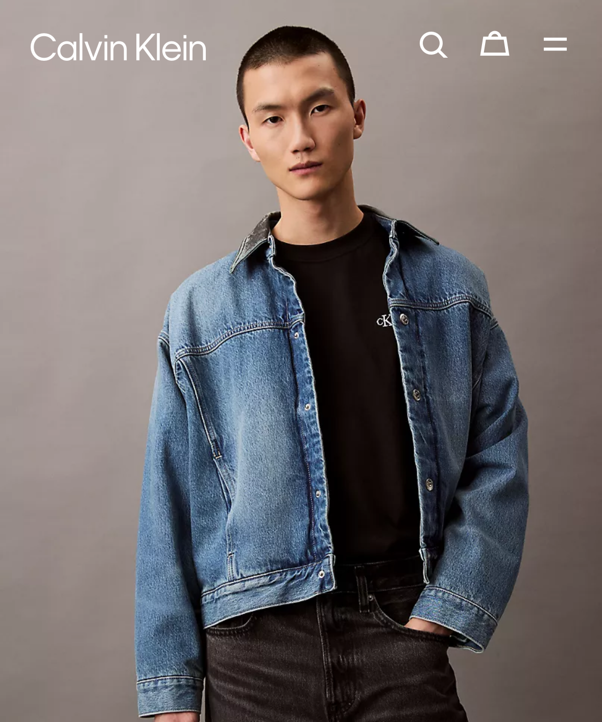 Calvin Klein product page with a model wearing a denim jacket on a gray background