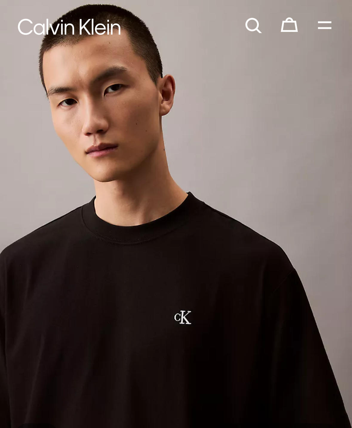Calvin Klein black t-shirt worn by a model on a website homepage